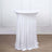 White stretch table cover on a cocktail table with two glasses.