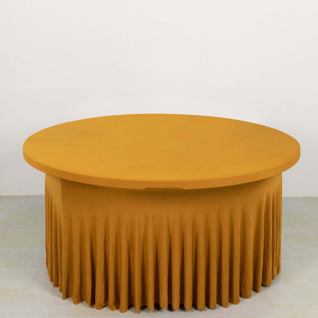 Round mustard yellow table with a pleated skirt