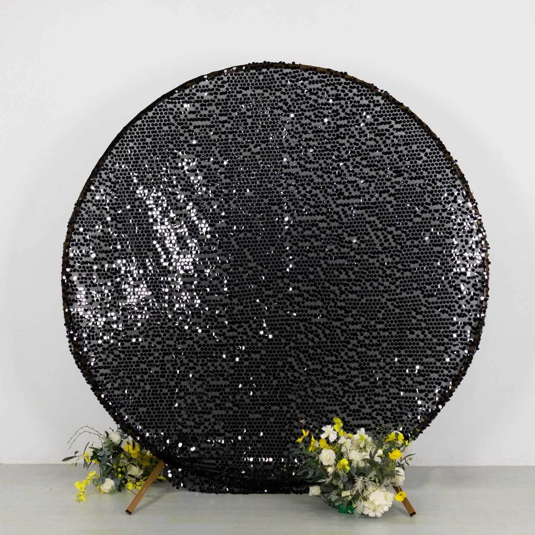 Black sequin round backdrop with floral accents