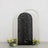 Black sequin backdrop with floral arrangements on the sides