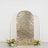 Gold sequin backdrop with floral arrangements, perfect for events and photo sessions.