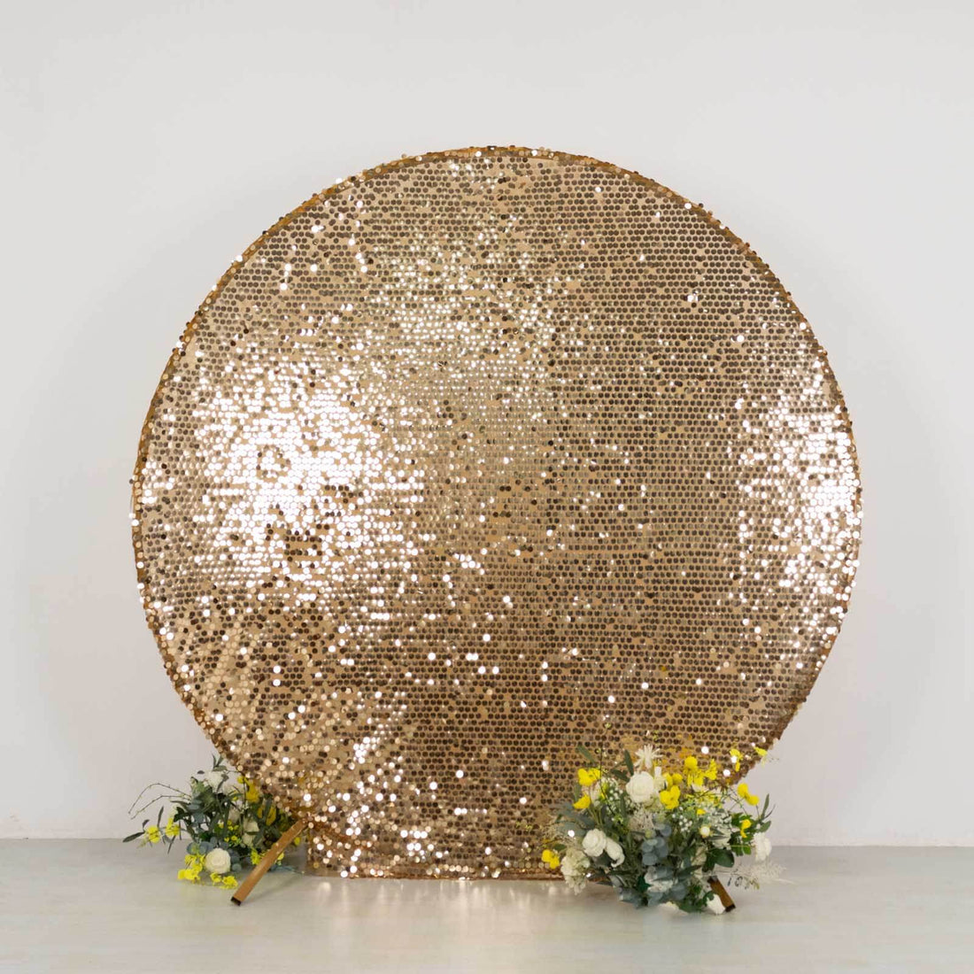 Gold sequin backdrop with flowers for events and photography.