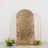 Gold sequin backdrop with floral arrangements on each side.