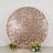 Rose gold sequin backdrop with floral arrangements at the base.