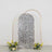 Decorative silver sequined backdrop with floral accents