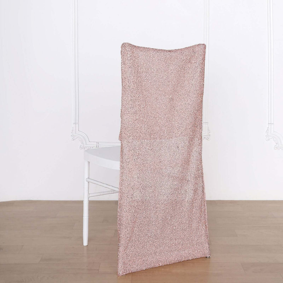Rose gold chair cover on a white chair against a plain background.