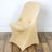 Beige stretch chair cover on a wooden floor.