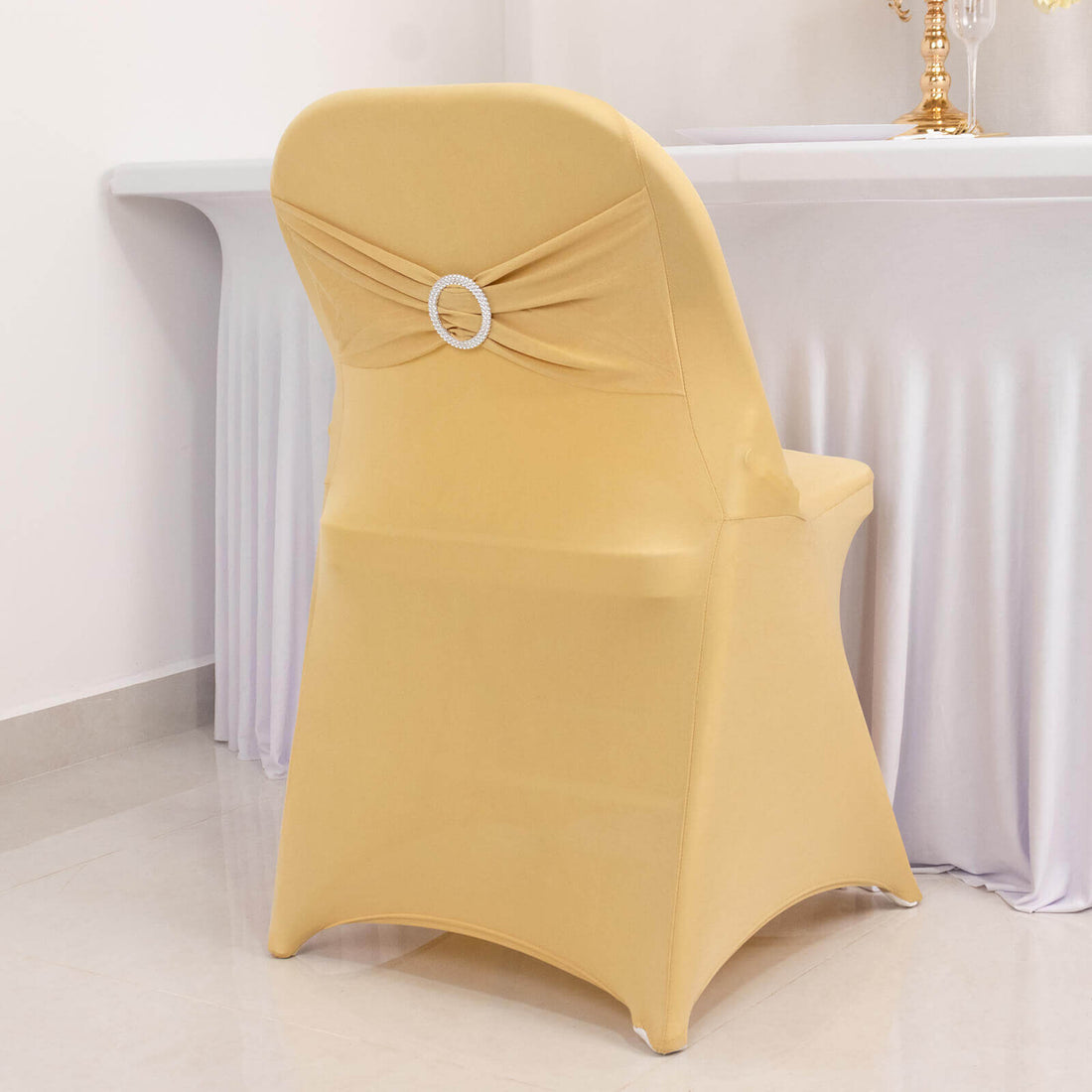 Yellow chair cover with decorative back detail against a plain backdrop.