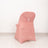 Pink chair cover with decorative ring detail on a plain backdrop.