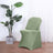 Green chair cover with a modern design in a stylish interior setting.
