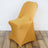 Orange chair cover on a sleek chair in a minimalist setting.