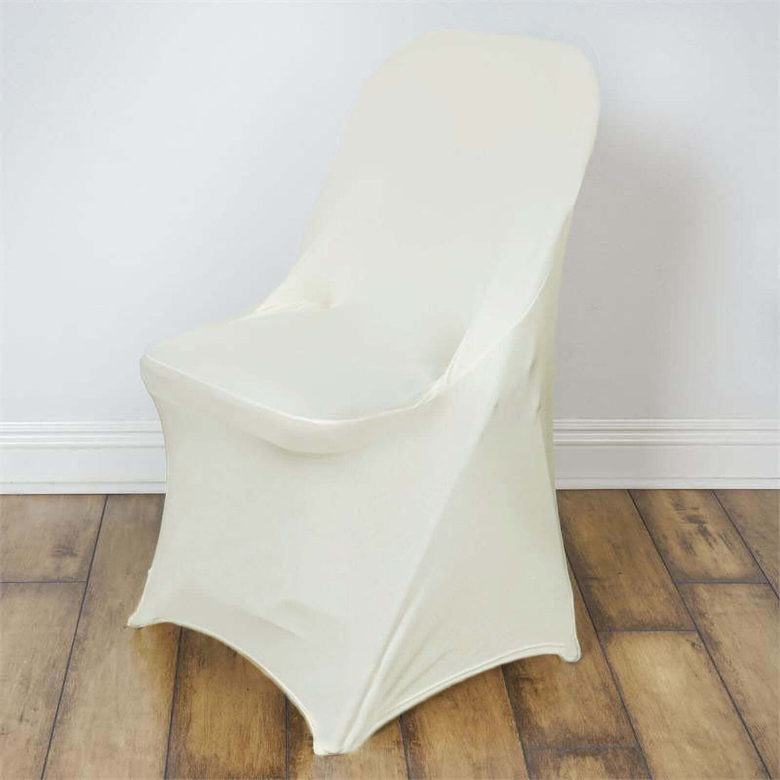 Cream-colored chair cover on a wooden floor.