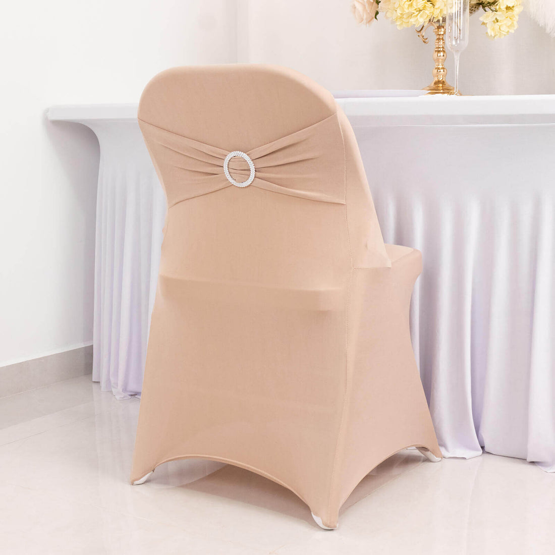 Elegant beige chair cover with decorative back detail