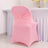 Pink chair cover with decorative bow for event seating.