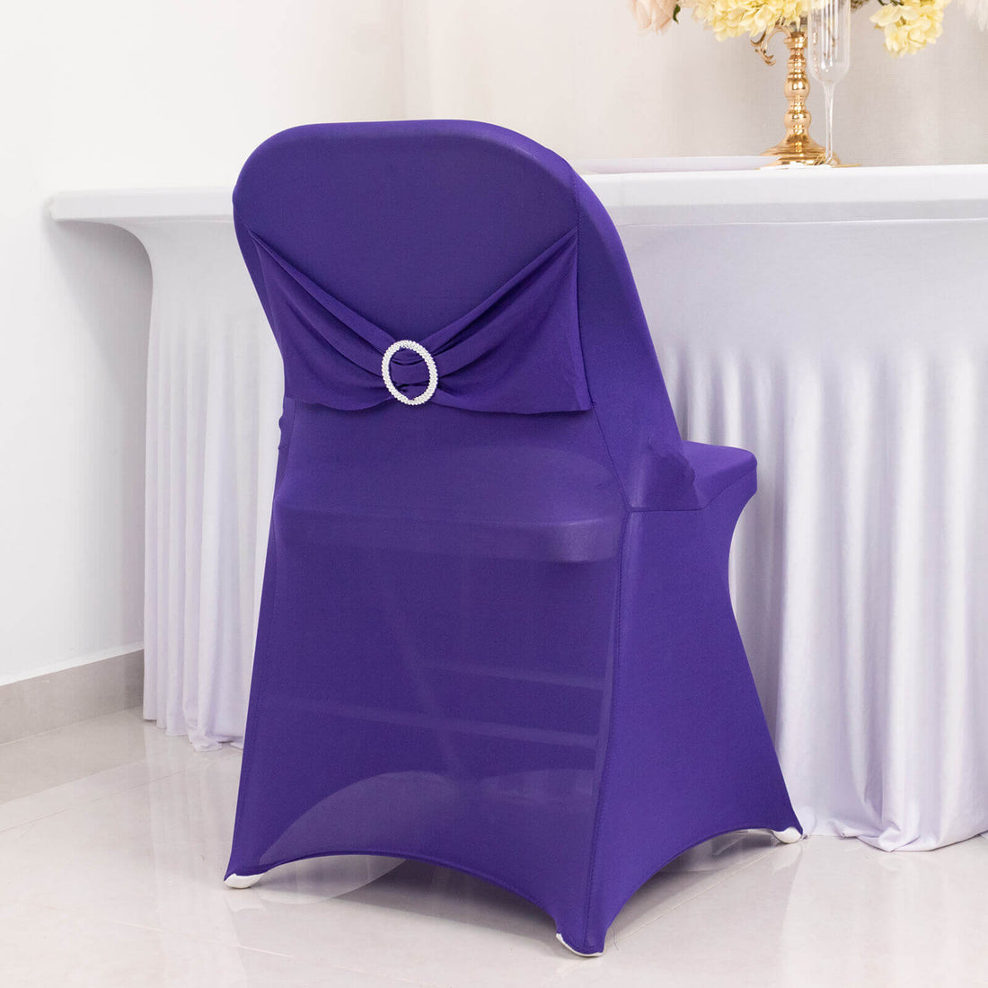 Purple chair cover with decorative back for elegant events.