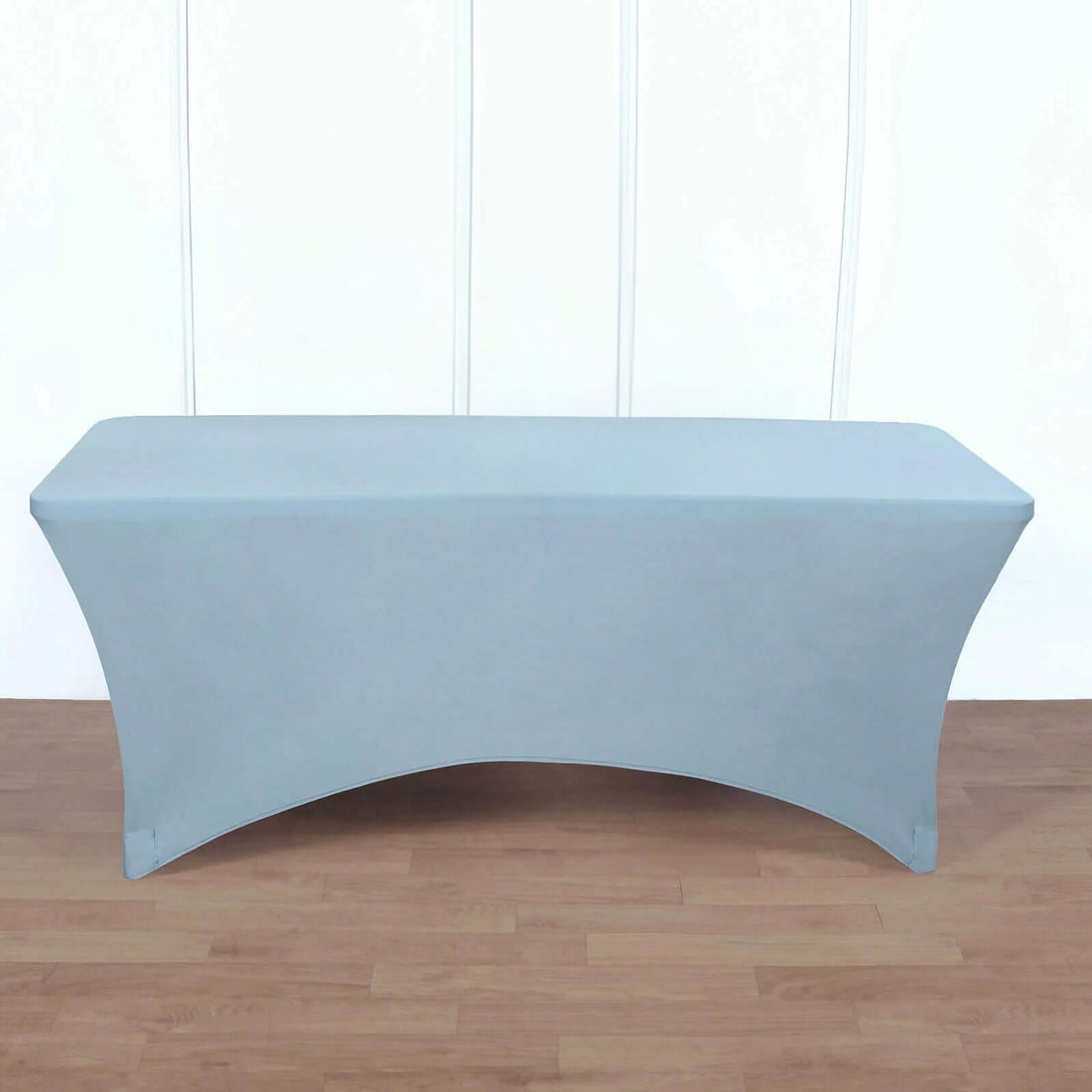 Blue stretch table cover on a wooden floor.