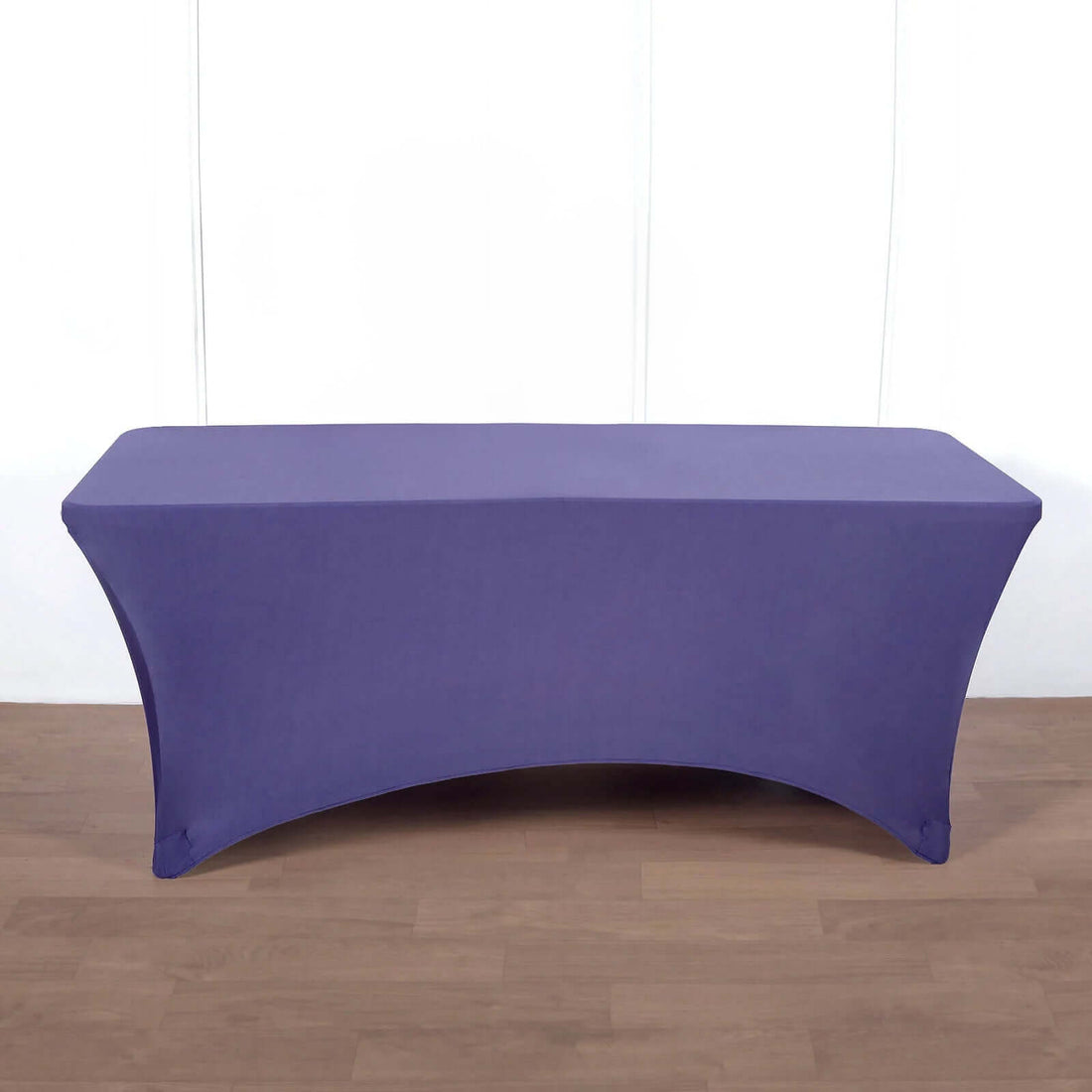 Purple stretch table cover on a wooden surface.