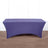 Purple stretch table cover on a wooden surface.