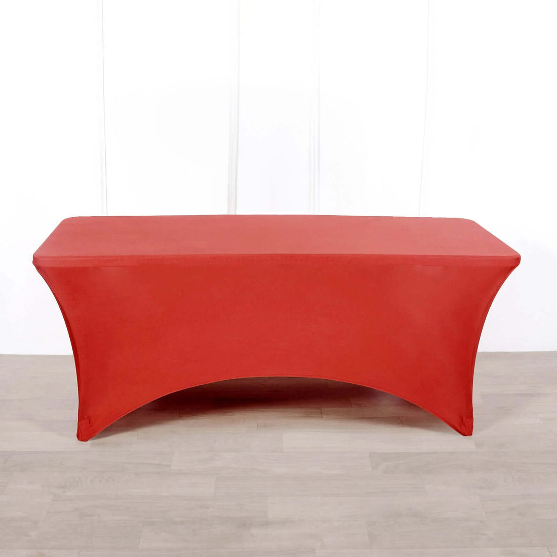 Red table cover on a plain backdrop for event styling.