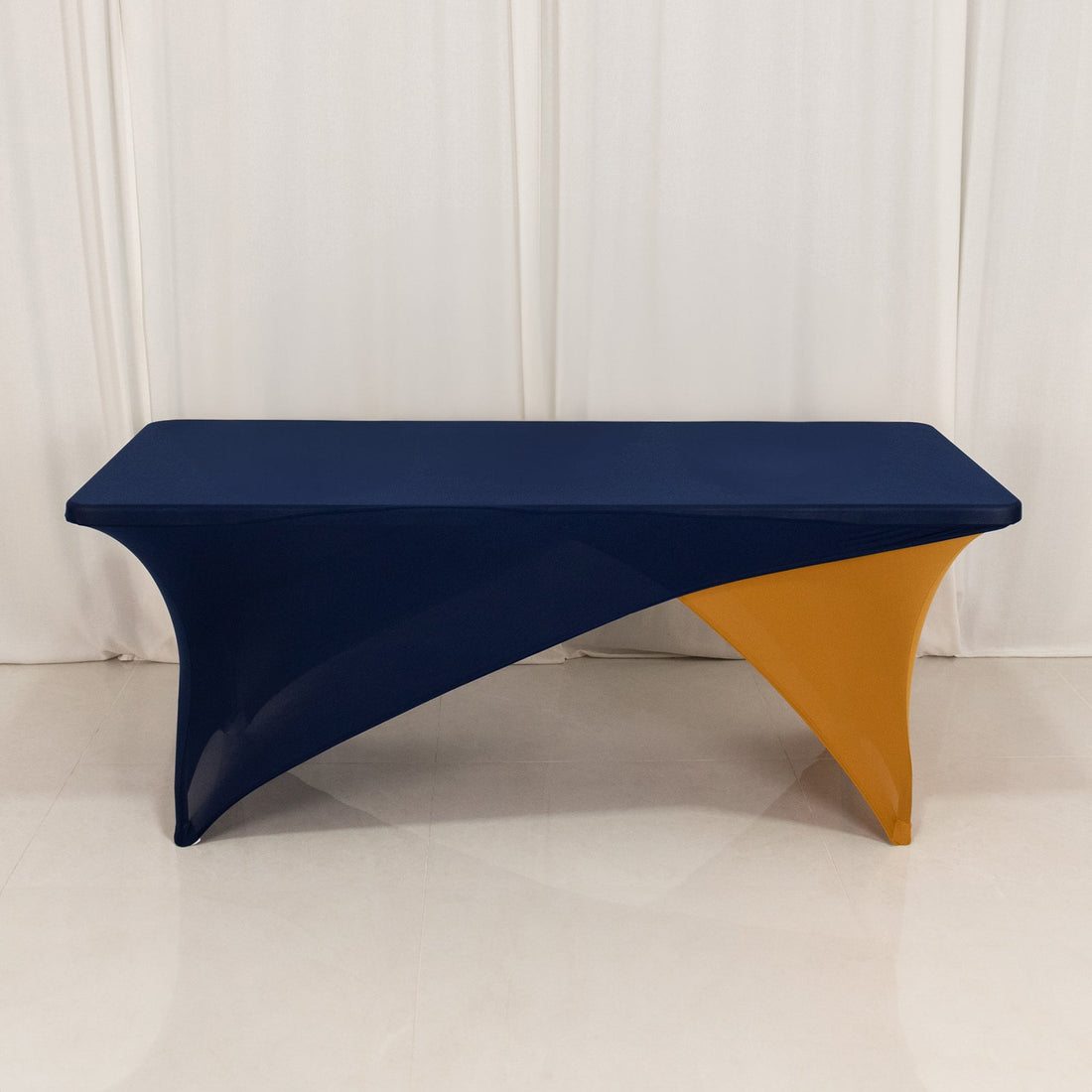 Navy and orange stretch table cover on a plain backdrop