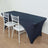Navy table cover with white chairs in a modern setting.