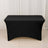 Black fitted table cover on a plain backdrop.