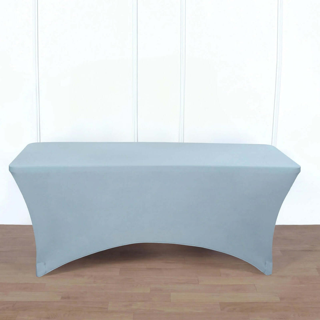 Gray fitted table cover on a wooden floor.
