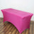 Pink table cover on a rectangular table with a smooth finish.
