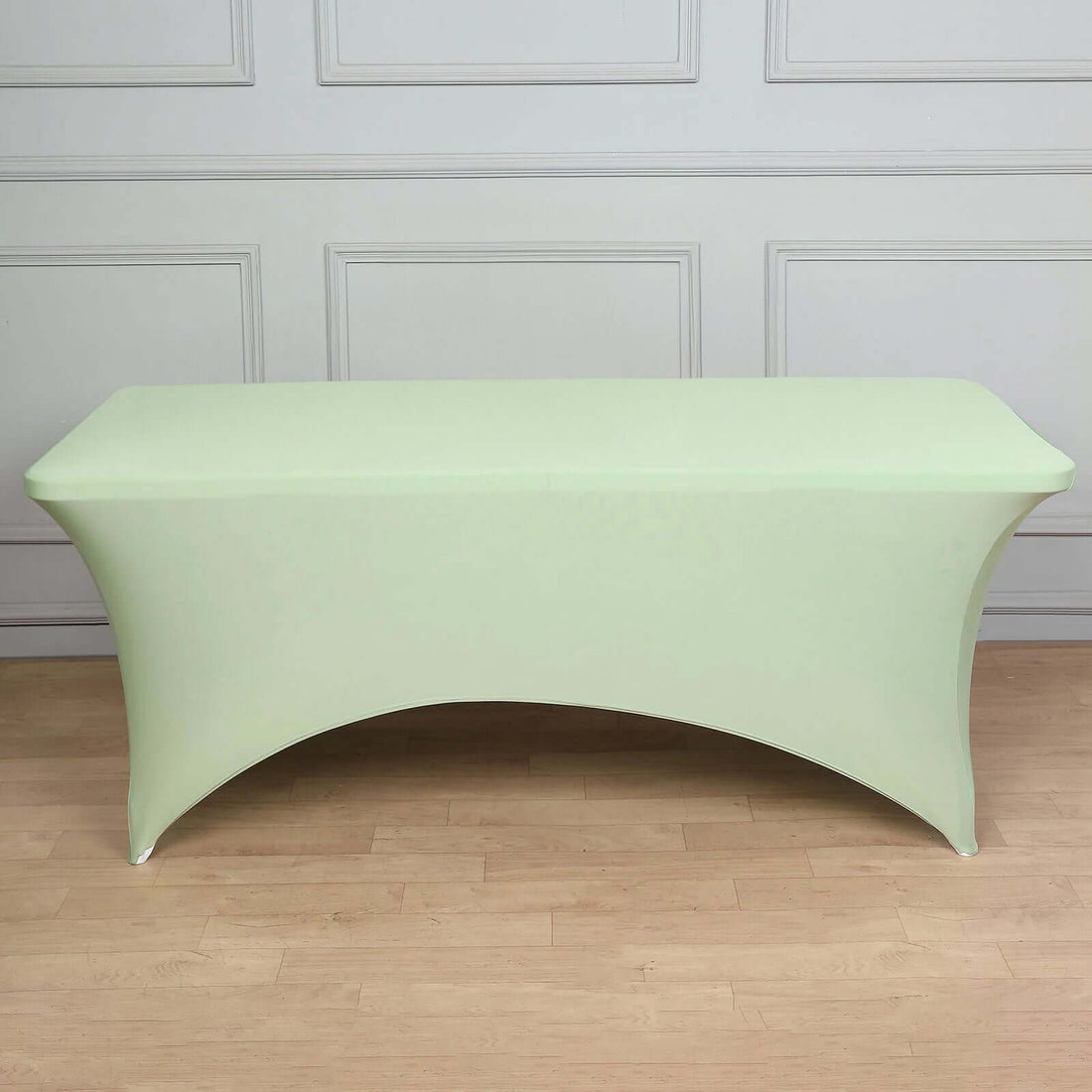Green stretch table cover on a plain backdrop