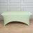 Green stretch table cover on a plain backdrop