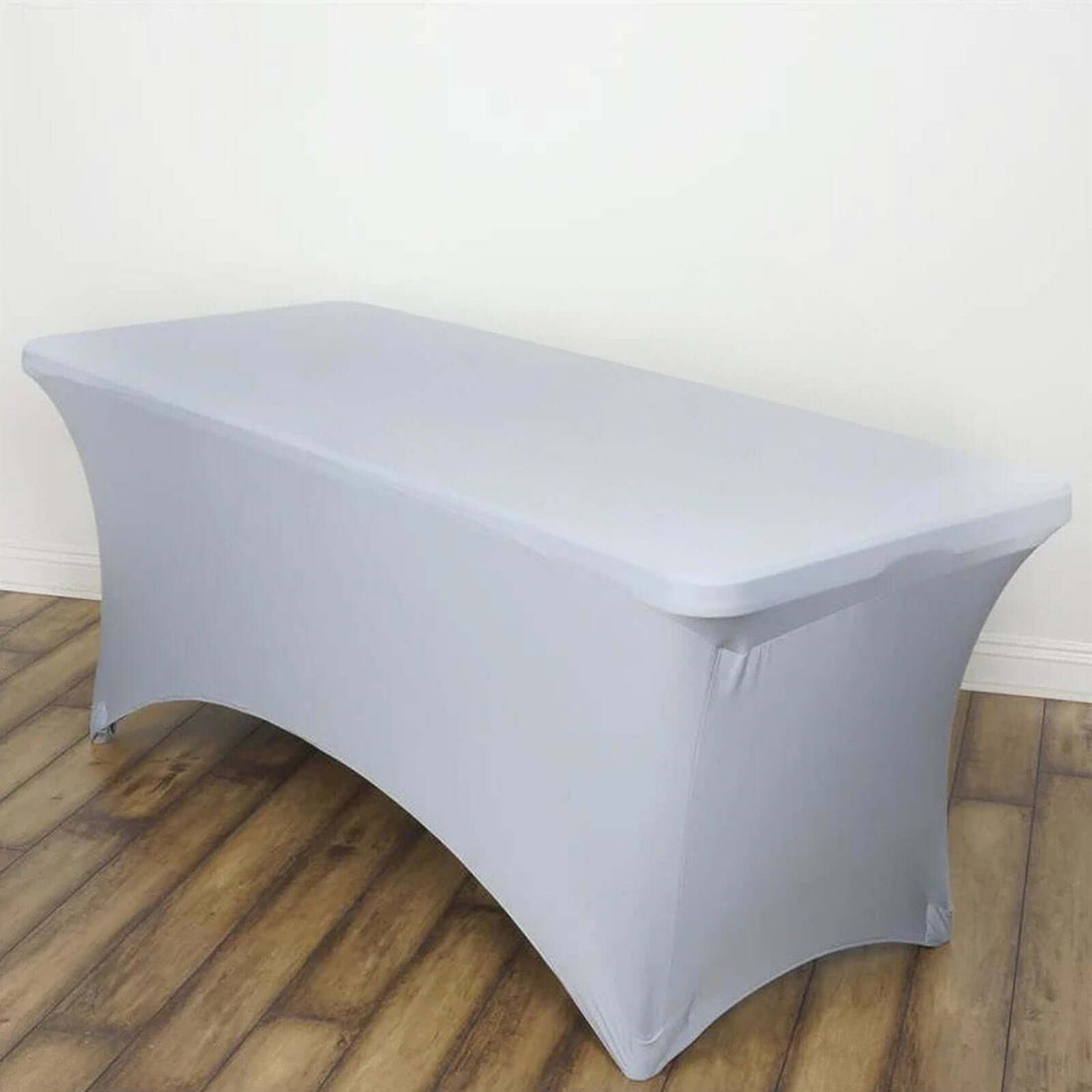 Gray fitted table cover on a plain backdrop.
