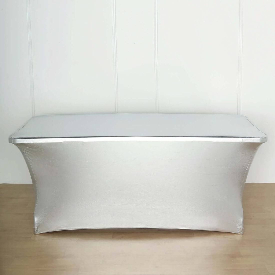 Silver table cover draped over a rectangular table.