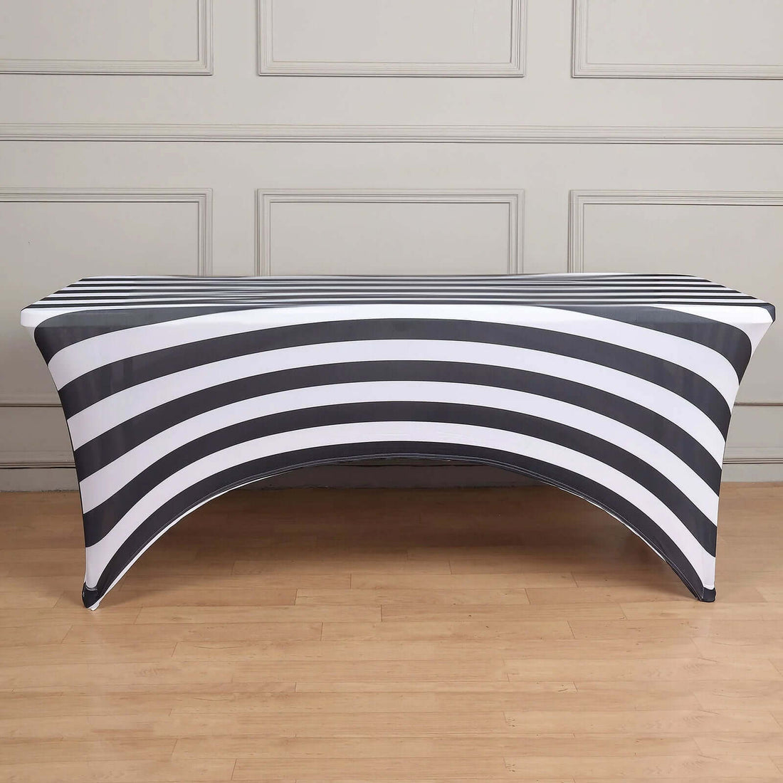 Black and white striped table cover on a wooden floor.
