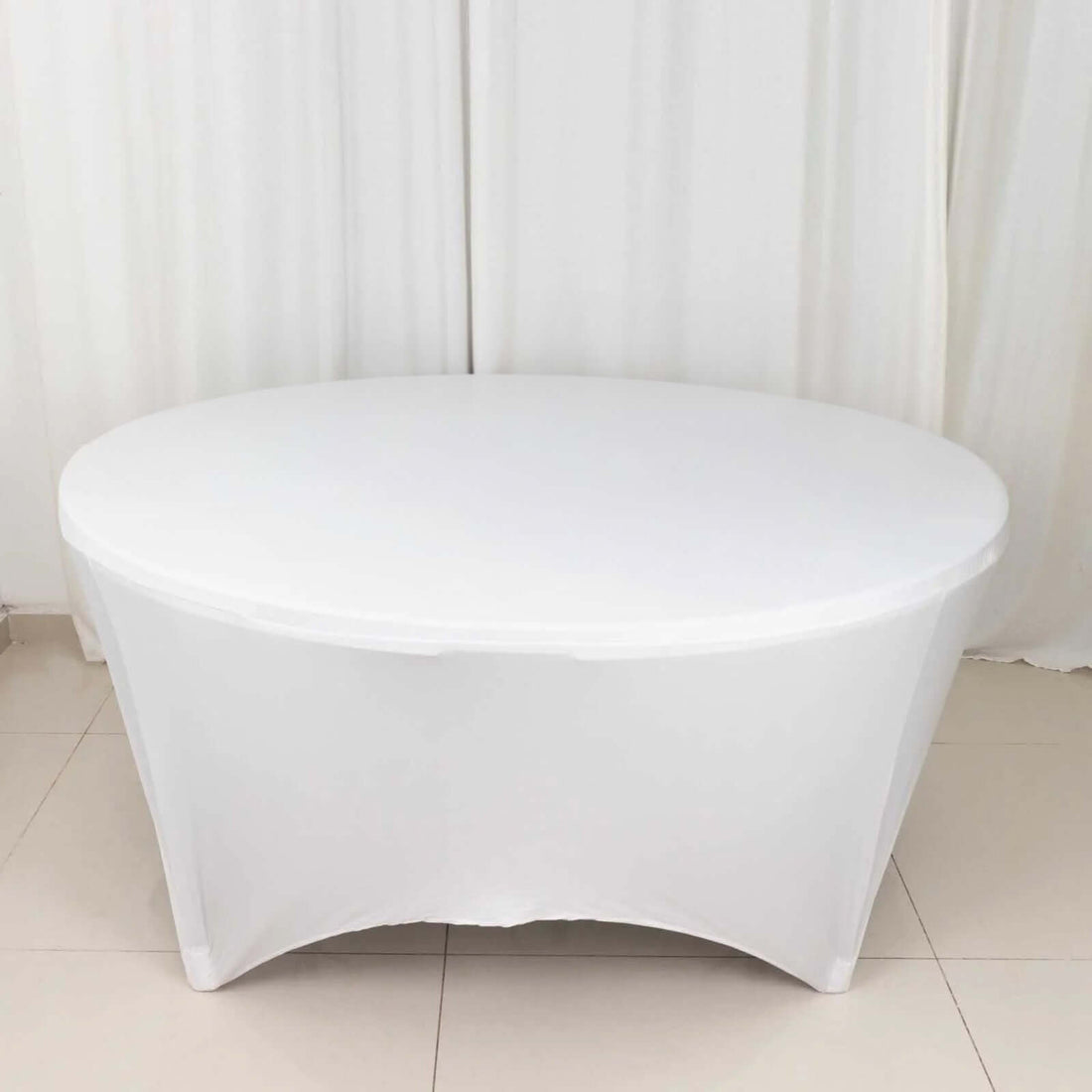 Round white table with a sleek design and smooth surface.