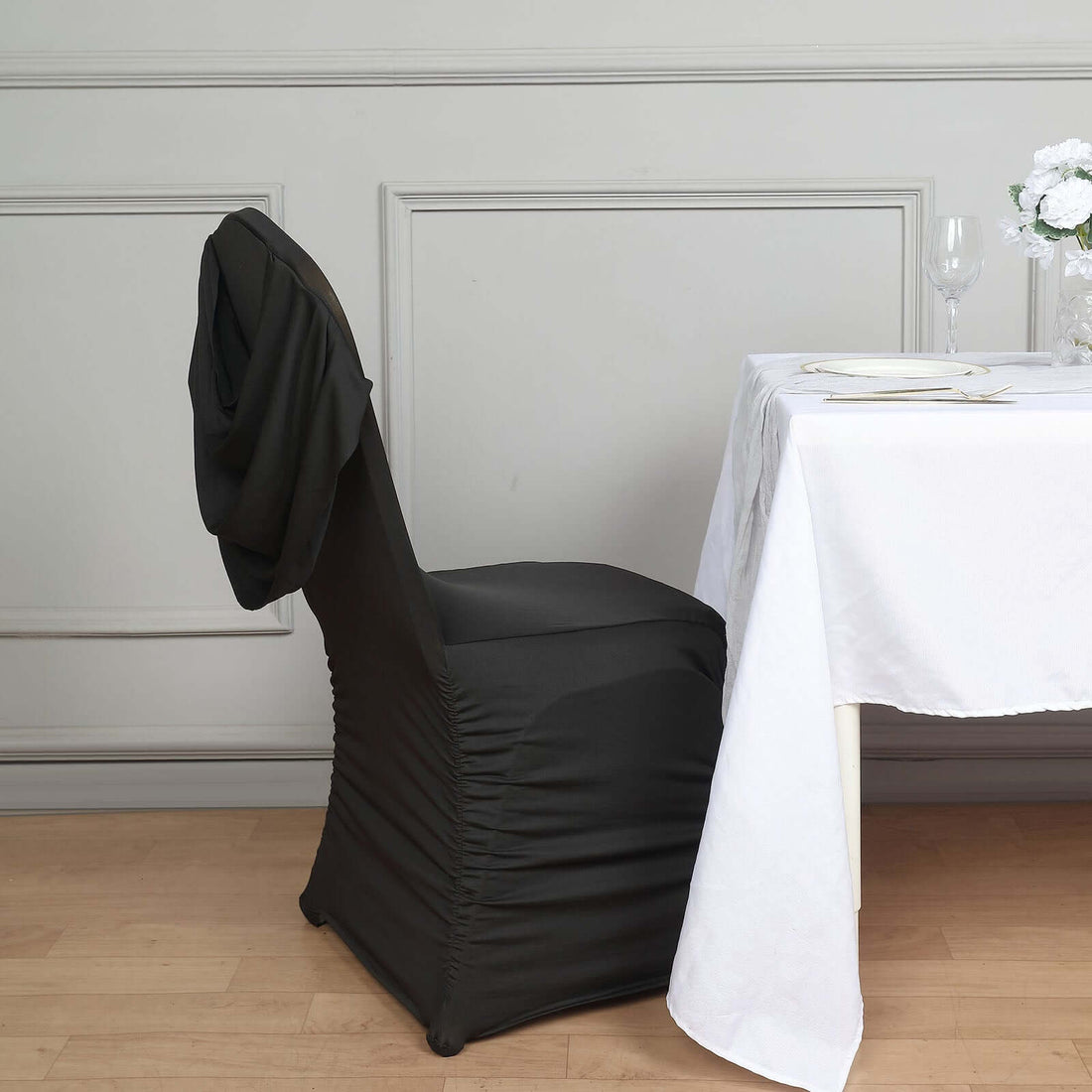 Black ruched swag-back banquet chair cover with decorative fitted design
