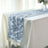 Elegant silver table runner with leaf design on a white tablecloth.