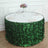 Green leaf table skirt with floral centerpiece and elegant table setting.