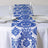 Blue and white damask table runner on a dining table setting.