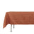 Orange tablecloth draped over a table, showcasing textured fabric.