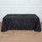 Black textured tablecloth draped over a table in a studio setting.