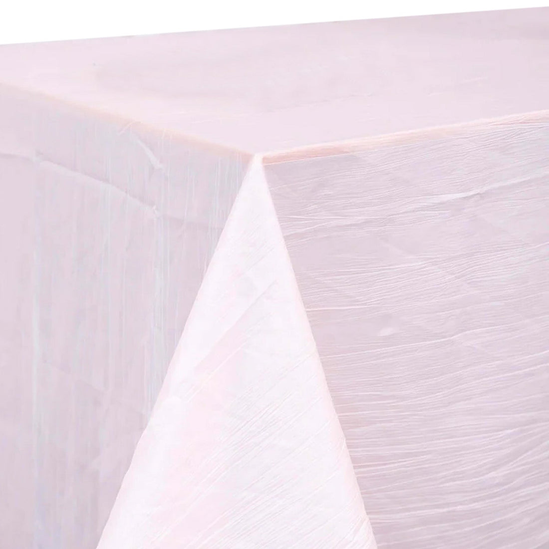 Pink textured tablecloth draped over a corner