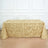 Gold fabric tablecloth with textured embellishments on a plain backdrop.