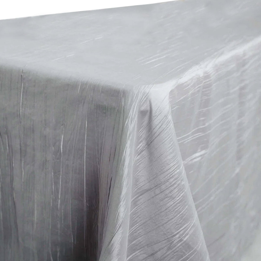 Silver crinkled tablecloth on a table edge