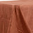 Textured rust-colored tablecloth draped over a table.