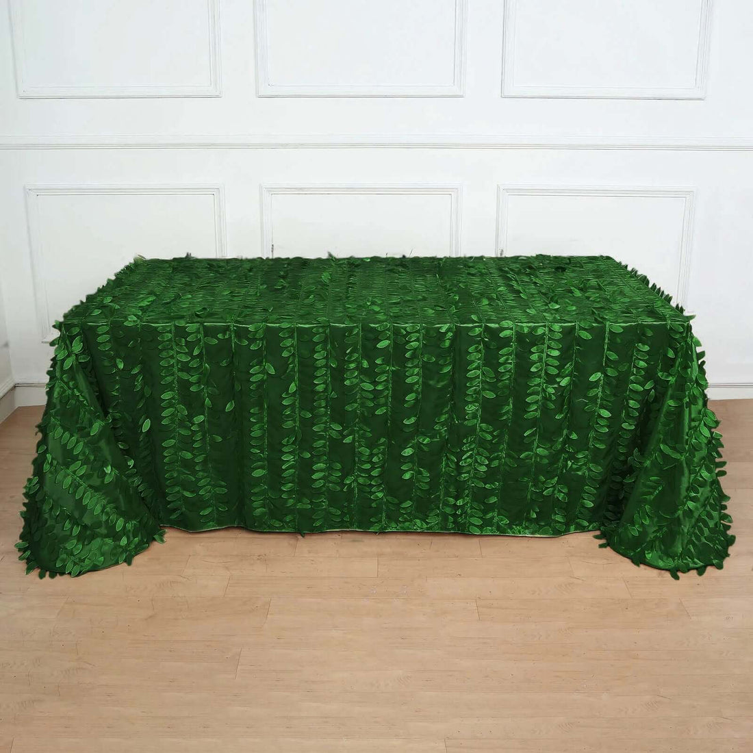 Green leaf tablecloth with textured design for events or decor.