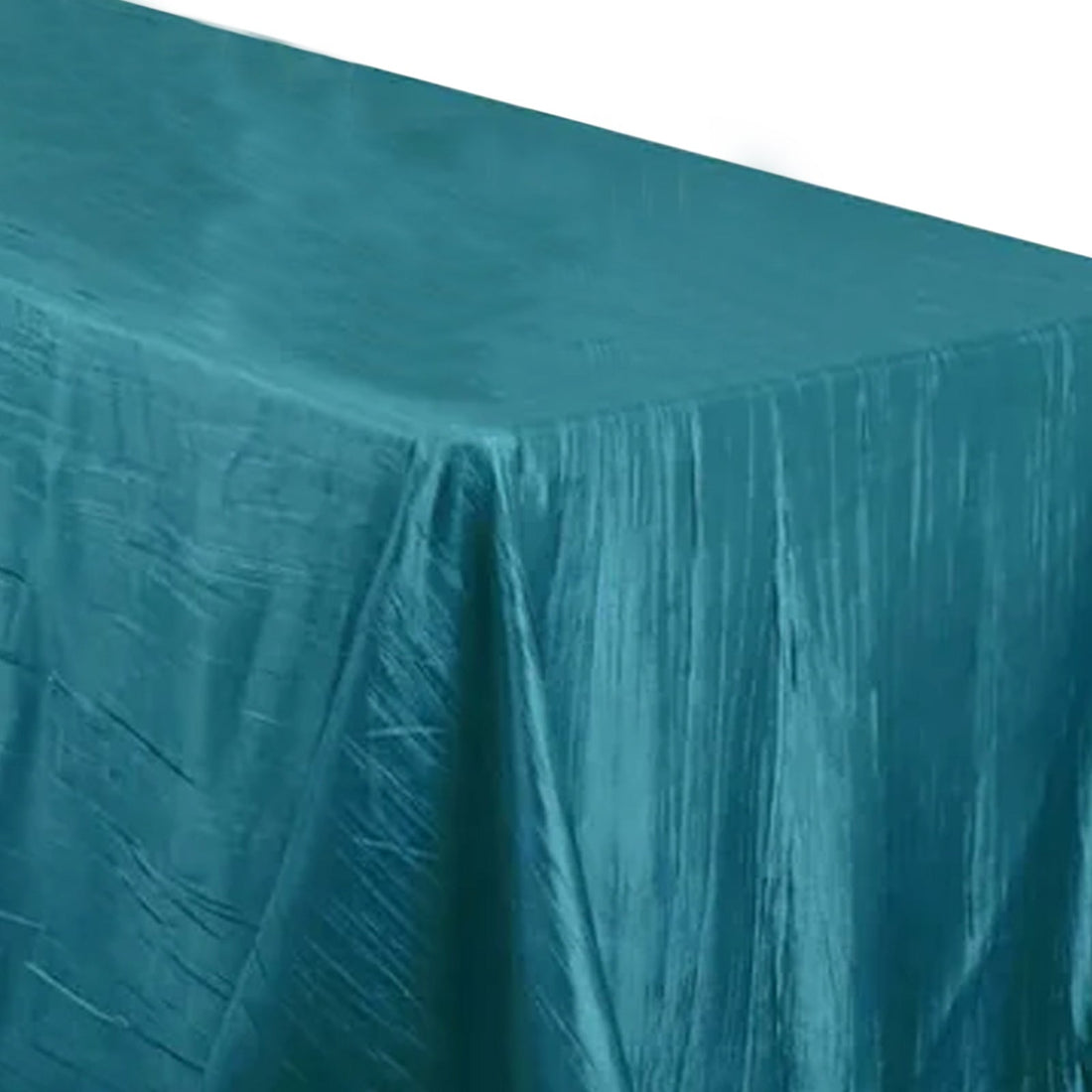 Teal tablecloth with a textured sheen on a plain background