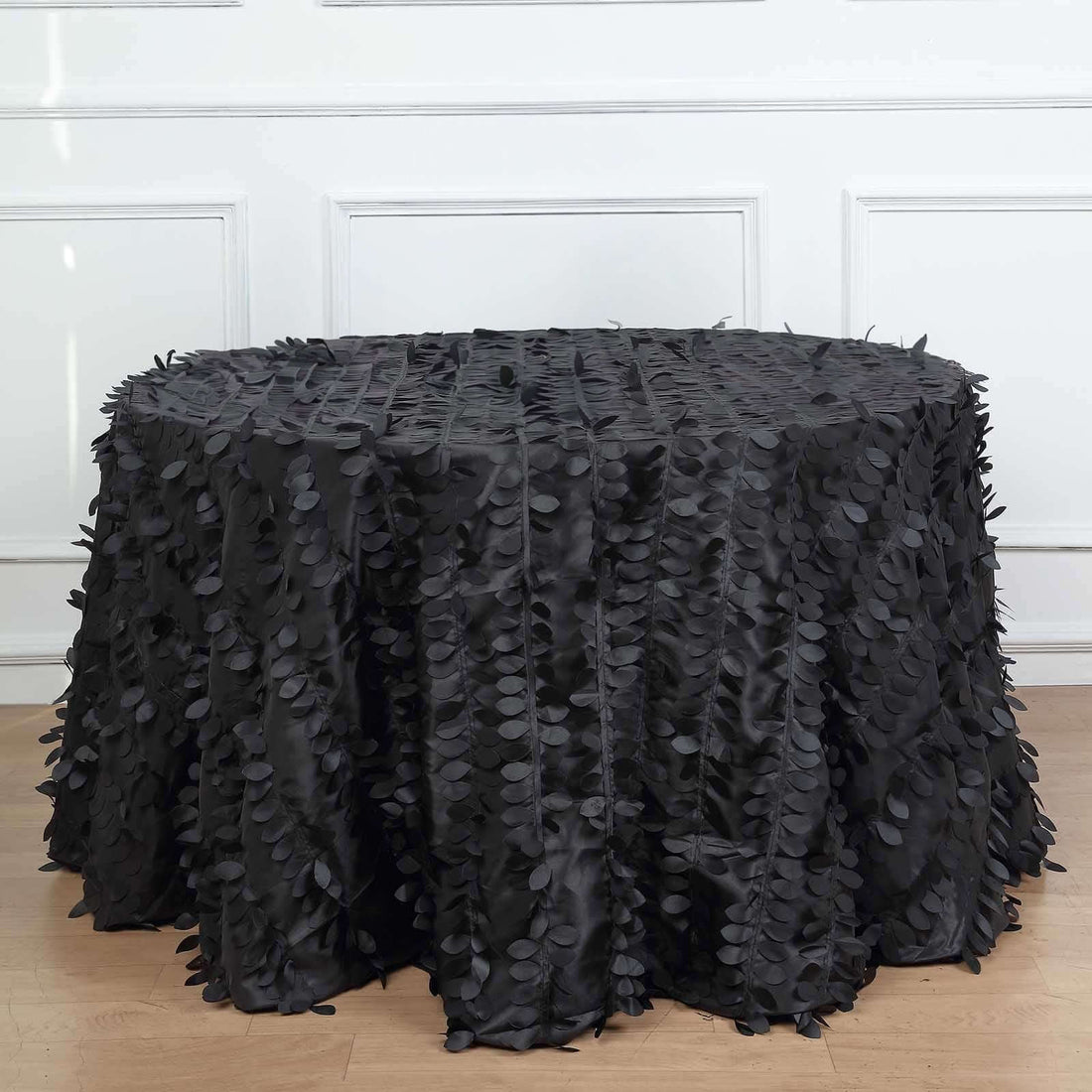 Black leaf-patterned tablecloth on a round table