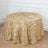 Gold leaf textured tablecloth draped on a round table.