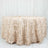 Beige tablecloth with leaf design on a round table.