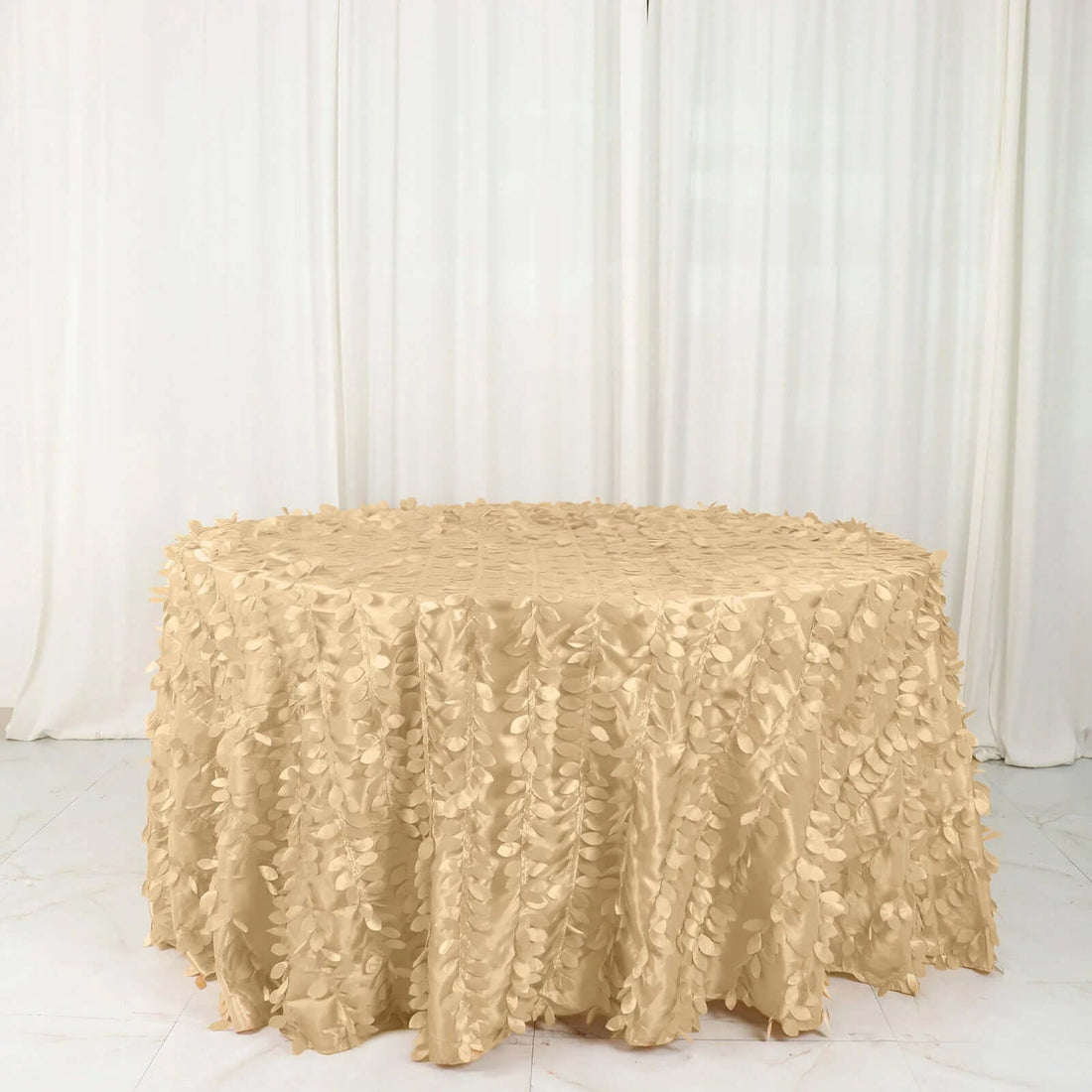 Beige tablecloth with leaf pattern on a round table.
